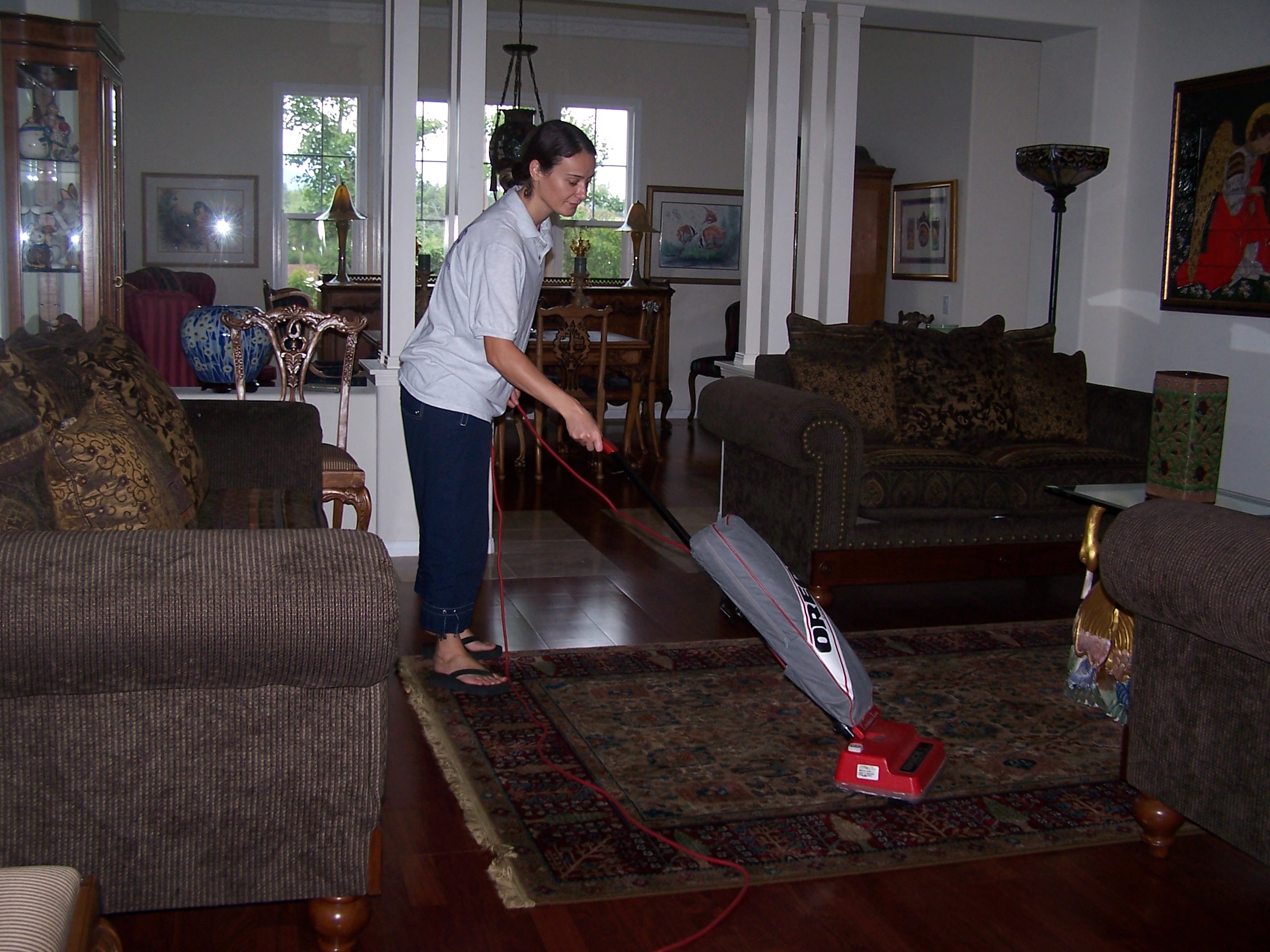 A picture of our staff vacuuming the floor