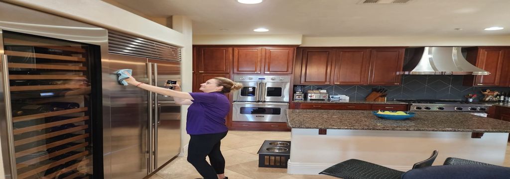 A picture of our staff cleaning fridge